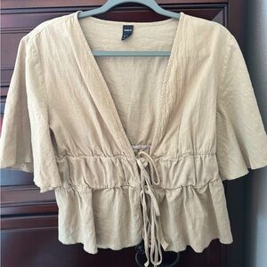 Beige flowy top that ties in the middle